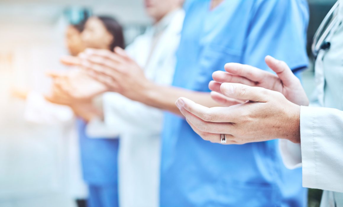 Clapping hands, celebration and team of doctors in the hospital with success in teamwork or collaboration. Solidarity, professional and group of healthcare workers with applause in a medical clinic.