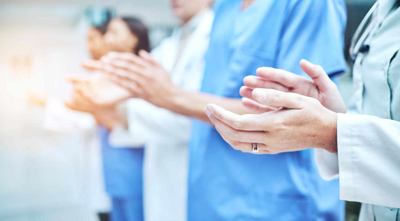 Clapping hands, celebration and team of doctors in the hospital with success in teamwork or collaboration. Solidarity, professional and group of healthcare workers with applause in a medical clinic.